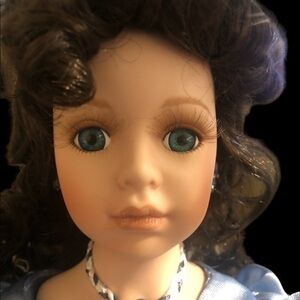 Porcelain doll with blue dress and feather hat Ava